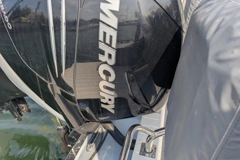 Slide: The Image of Mercury outboard engine on 2019 Axopar 28 CABIN boat, docked on water. - 7