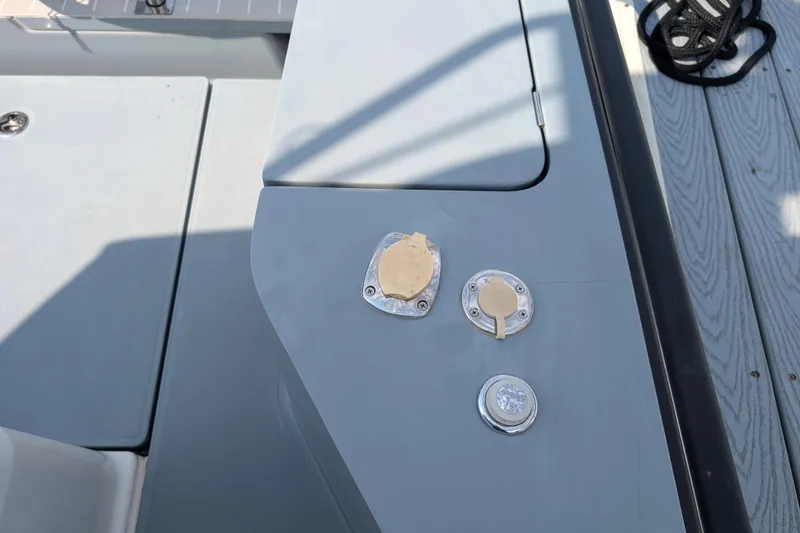 Slide: The Image of 2019 Axopar 28 CABIN deck with utility access points and fittings. - 20