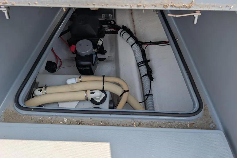 Slide: The Image of 2019 Axopar 28 CABIN boat compartment with hoses and wiring. - 15