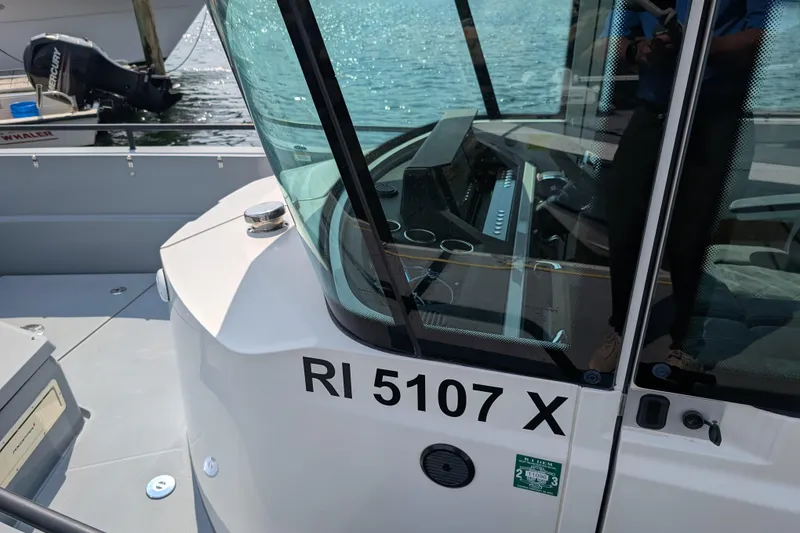 Slide: The Image of 2019 Axopar 28 CABIN boat docked, showing registration number RI 5107 X. - 57
