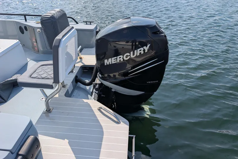 Slide: The Image of 2019 Axopar 28 CABIN with Mercury Verado engine on calm water. - 5