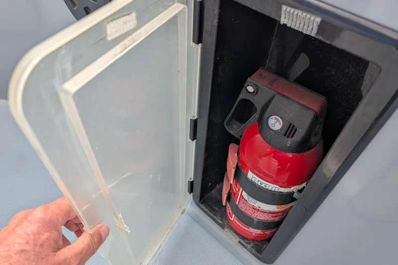 Slide: The Image of Fire extinguisher in storage compartment of 2019 Axopar 28 CABIN boat. - 43