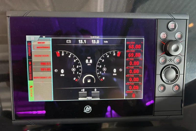 Slide: The Image of 2021 Formula 330 Crossover Bowrider I/O dashboard with steering wheel and navigation controls. - 10