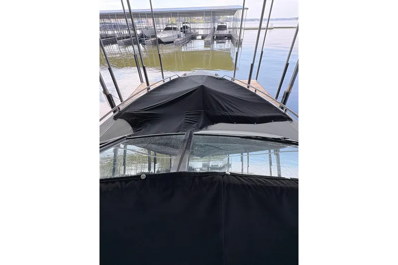 Slide: The Image of 2021 Formula 330 Crossover Bowrider I/O docked under a covered marina. - 17