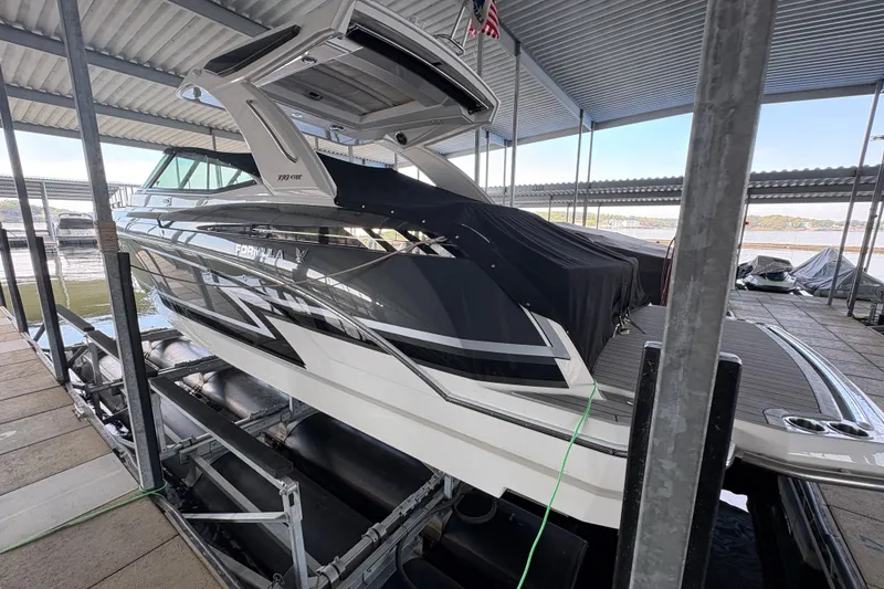 Slide: The Image of 2021 Formula 330 Crossover Bowrider I/O docked in a covered marina. - 2