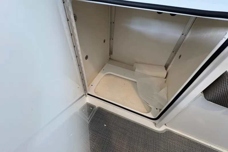 Slide: The Image of Storage compartment in 2021 Formula 330 Crossover Bowrider I/O, featuring organized interior space. - 27