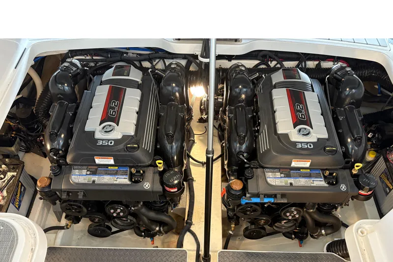 Slide: The Image of 2021 Formula 330 Crossover Bowrider I/O with open engine compartment in marina setting. - 38