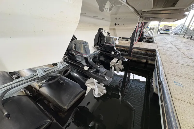 Slide: The Image of 2021 Formula 330 Crossover Bowrider I/O with dual outboard motors in water. - 49