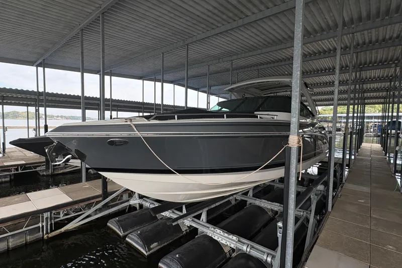 Slide: The Image of 2021 Formula 330 Crossover Bowrider I/O docked under a covered marina. - 5