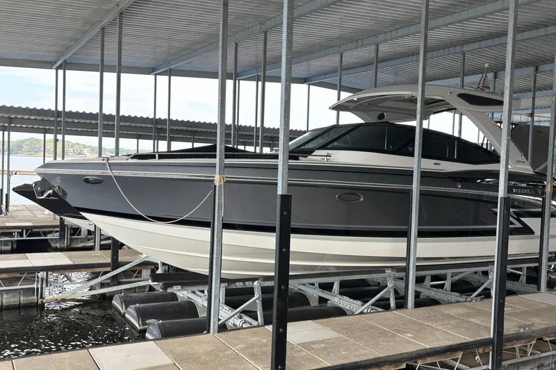 Slide: The Image of 2021 Formula 330 Crossover Bowrider I/O docked in a covered marina. - 6