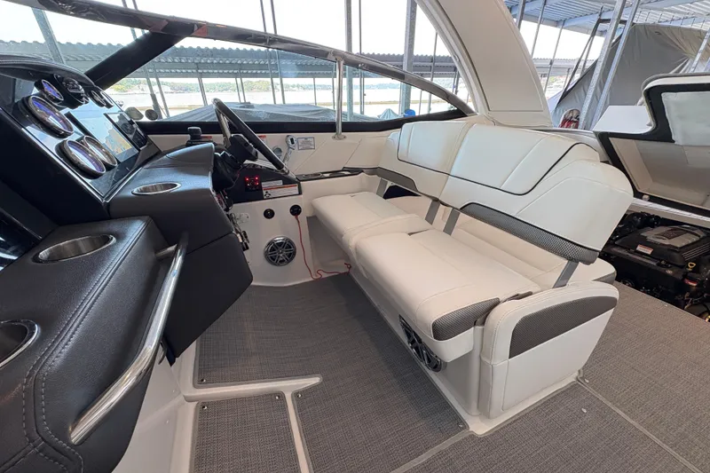Slide: The Image of 2021 Formula 330 Crossover Bowrider I/O with covered deck and cup holders. - 8