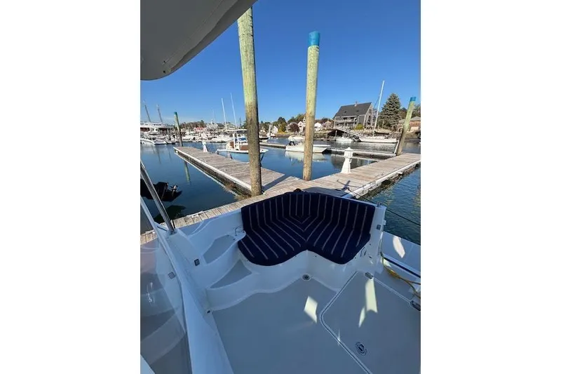 Slide: The Image of 2018 Back Cove 30 boat with striped seating at a marina dock. - 12