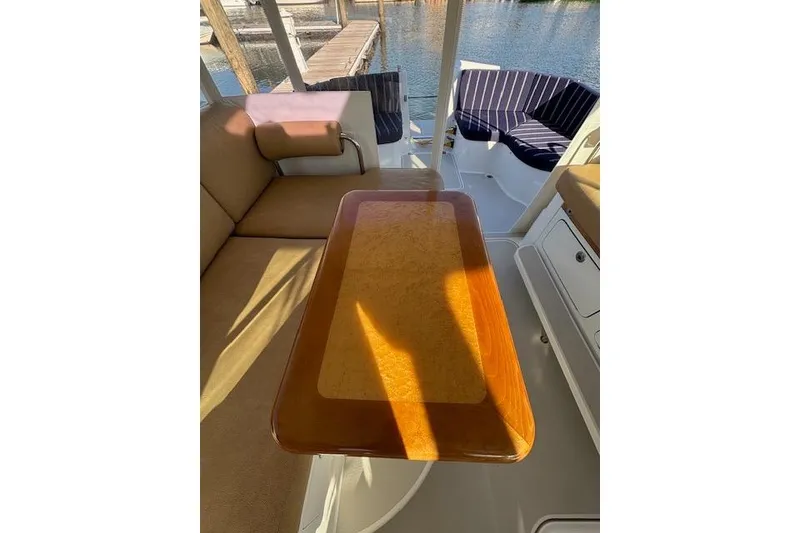 Slide: The Image of Interior of 2018 Back Cove 30 boat with wooden table and cushioned seating. - 17