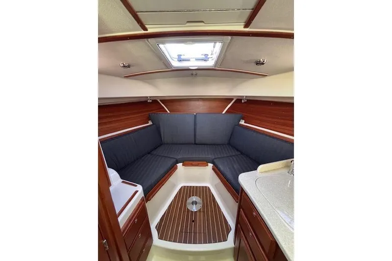 Slide: The Image of 2018 Back Cove 30 interior with cozy seating and wooden accents. - 25