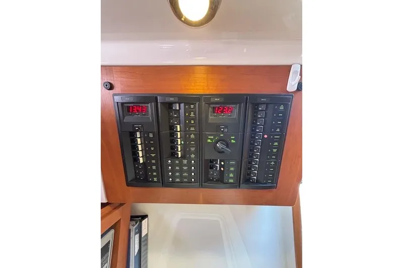 Slide: The Image of Electrical panel of a 2018 Back Cove 30 boat with digital displays and switches. - 39