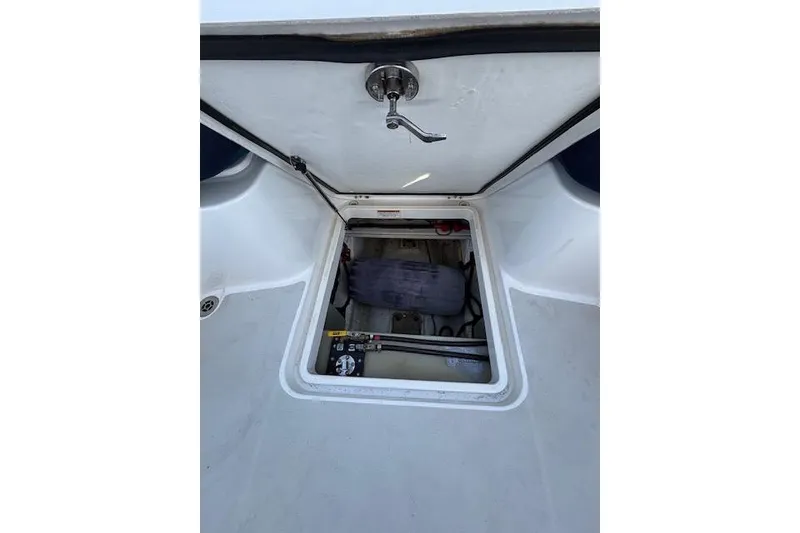 Slide: The Image of Open hatch on 2018 Back Cove 30 boat, revealing storage compartment. - 40