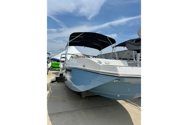 The Image of 2026 Starcraft SVX 211 OB boat with canopy, displayed outdoors under a clear sky. - 1