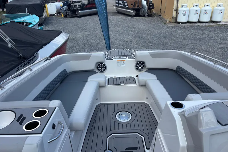 Slide: The Image of 2026 Starcraft SVX 211 OB boat interior with gray seating and cup holders. - 10