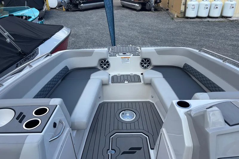 Slide: The Image of 2026 Starcraft SVX 211 OB boat interior with gray seating and cup holders. - 12