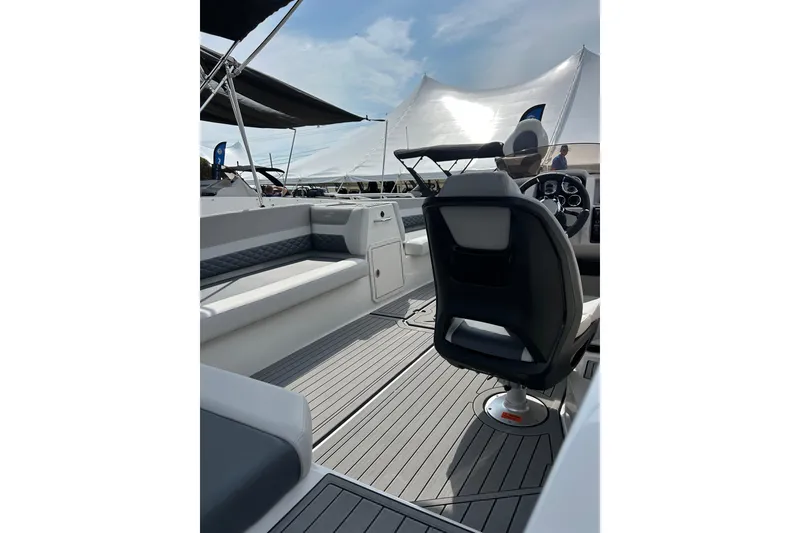 Slide: The Image of 2026 Starcraft SVX 211 OB boat interior with sleek seating and modern steering console. - 3