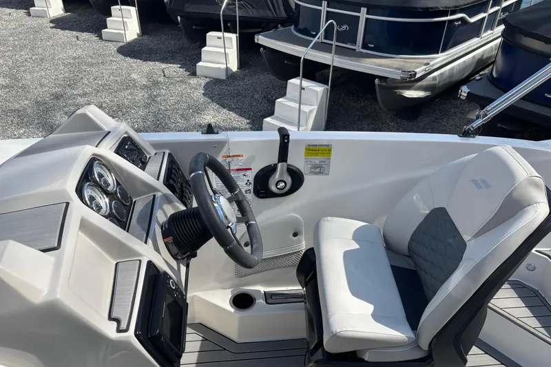 Slide: The Image of 2026 Starcraft SVX 211 OB boat interior with steering wheel and captain's seat. - 7
