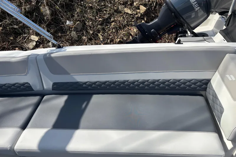 Slide: The Image of 2026 Starcraft SVX 211 OB boat interior with gray cushioned seating and Yamaha outboard motor. - 9