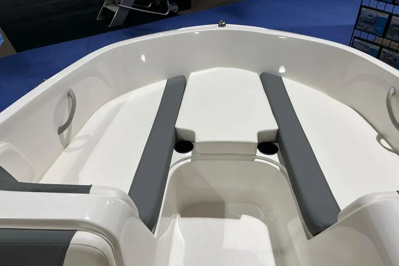 Slide: The Image of 2026 Bayliner Element E18 boat interior with gray seating and cup holders. - 11