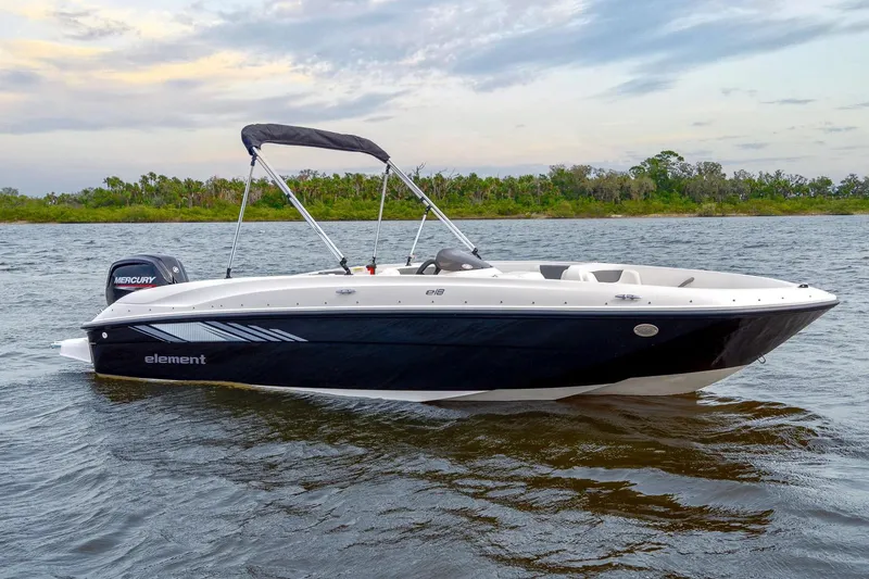 Slide: The Image of 2026 Bayliner Element E18 boat displayed indoors with Mercury engine. - 2