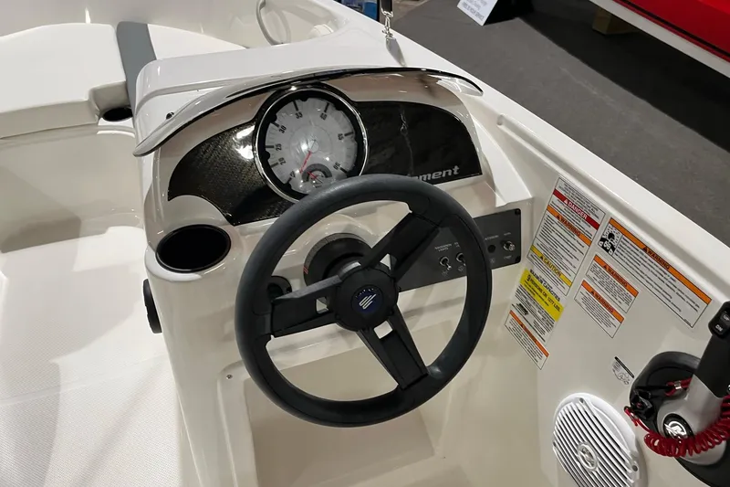 Slide: The Image of 2026 Bayliner Element E18 boat dashboard with steering wheel and instrument panel. - 9