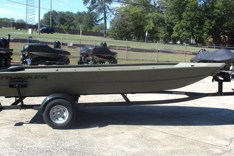 Slide: The Image of 2026 Tracker Grizzly 1754 Utility boat on trailer, parked outdoors. - 4