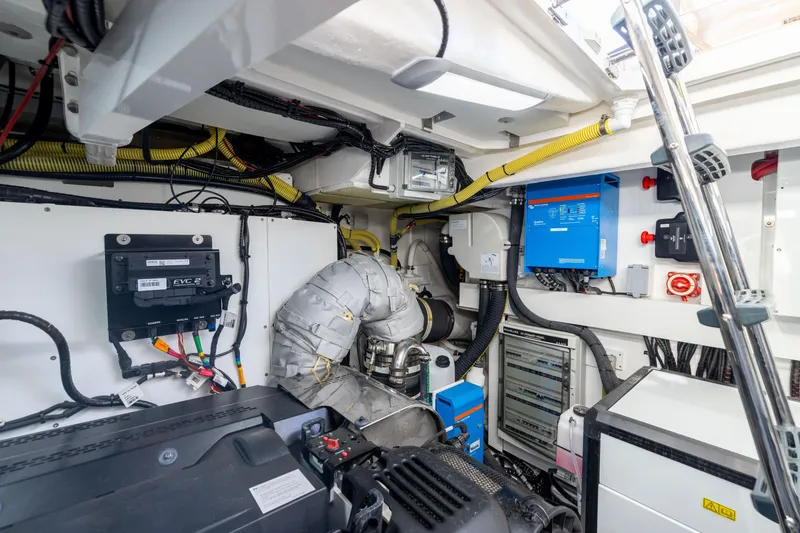 Slide: The Image of Engine room of 2025 Fairline Squadron 58 yacht, showcasing advanced machinery and wiring. - 100