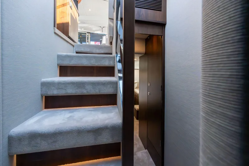 Slide: The Image of Luxury outdoor seating on 2025 Fairline Squadron 58 yacht, overlooking serene water and shoreline. - 16