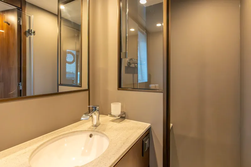 Slide: The Image of Luxury Fairline Squadron 58 yacht deck overlooking serene blue waters, 2025 model. - 20