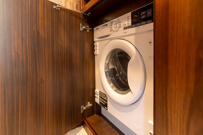 Slide: The Image of Luxurious 2025 Fairline Squadron 58 yacht interior with modern kitchen and bar stools. - 21