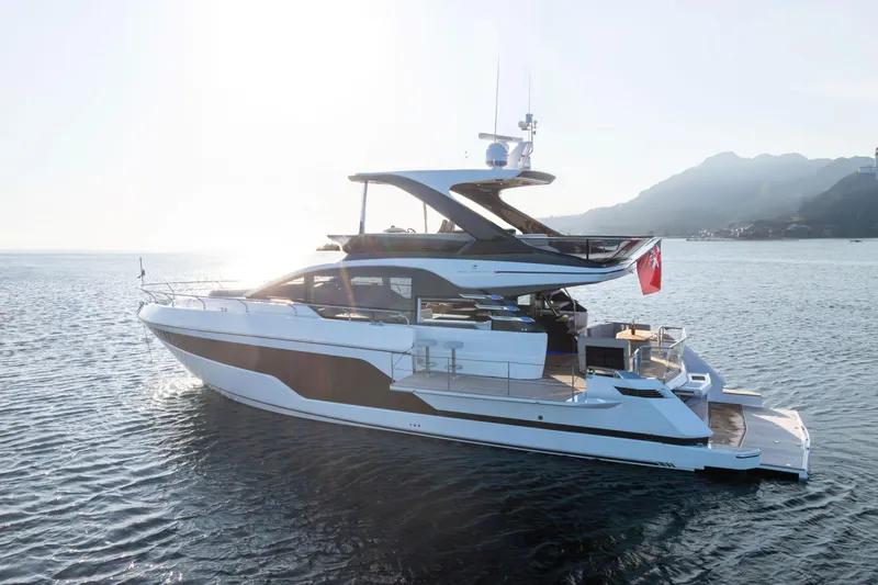 Slide: The Image of Luxury 2025 Fairline Squadron 58 yacht docked by autumn trees. - 3