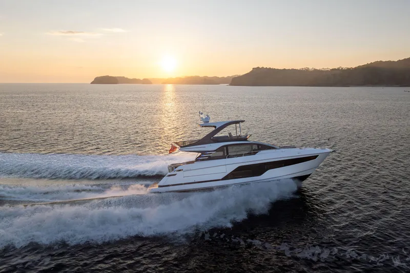 Slide: The Image of 2025 Fairline Squadron 58 luxury yacht on calm water, aerial view. - 4