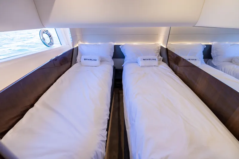 Slide: The Image of Twin beds in the luxurious 2025 Fairline Squadron 58 yacht cabin. - 42
