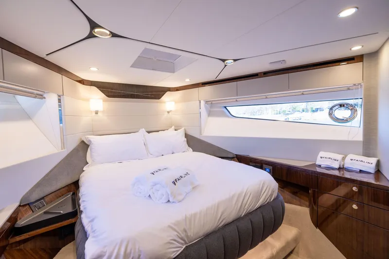 Slide: The Image of Luxurious bedroom interior of 2025 Fairline Squadron 58 yacht, featuring elegant design and plush bedding. - 44