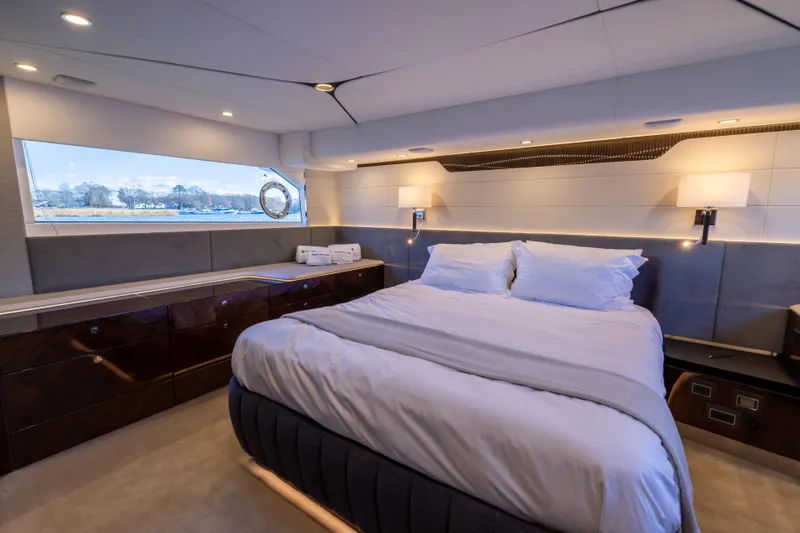 Slide: The Image of Luxurious bedroom interior of 2025 Fairline Squadron 58 yacht with elegant design and scenic window view. - 50
