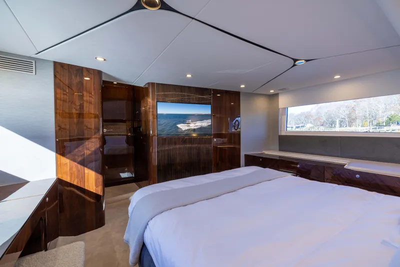 Slide: The Image of Luxurious interior of 2025 Fairline Squadron 58 yacht with elegant wood finishes and scenic window view. - 56