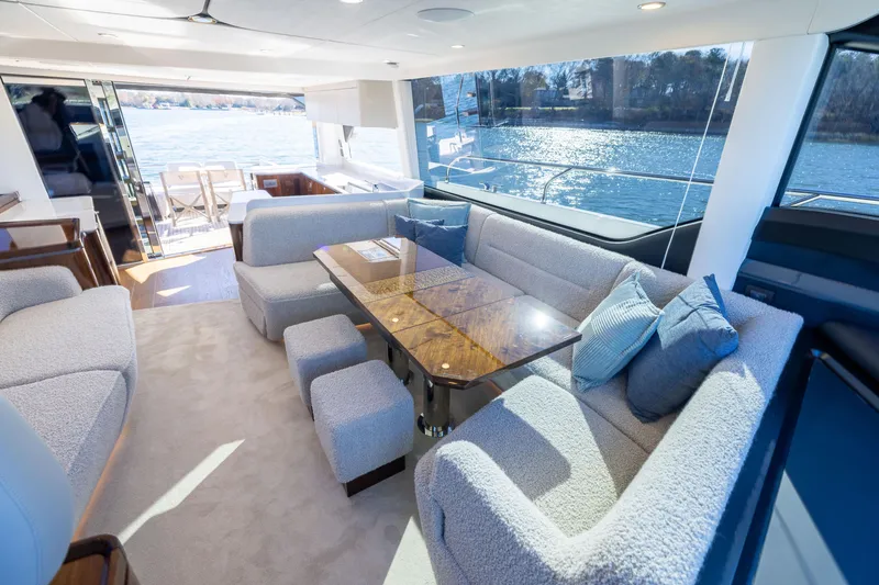 Slide: The Image of Luxurious interior of 2025 Fairline Squadron 58 yacht with elegant seating and panoramic windows. - 66