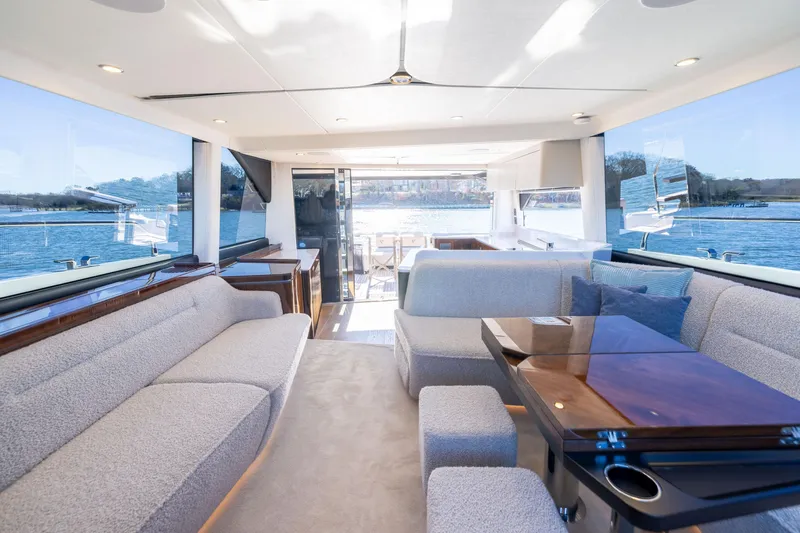 Slide: The Image of Luxurious interior of 2025 Fairline Squadron 58 yacht with elegant seating and panoramic windows. - 67