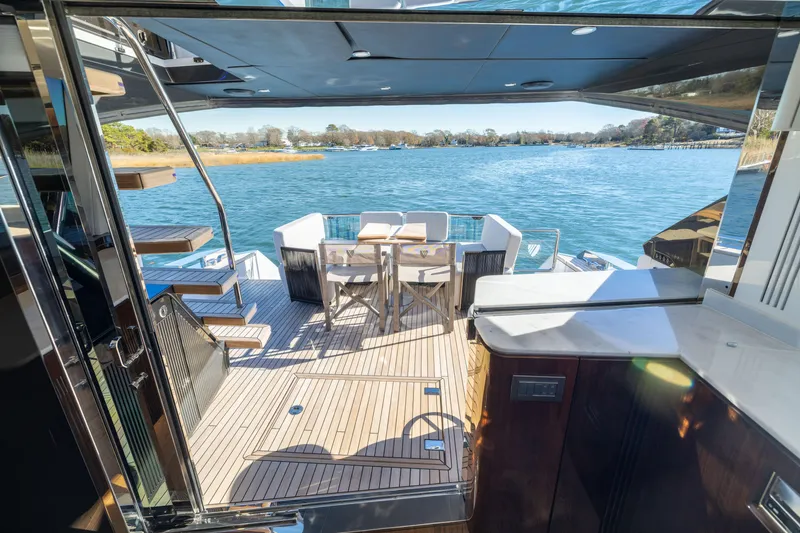 Slide: The Image of Luxury yacht Fairline Squadron 58, 2025 model, with elegant deck and scenic water view. - 70