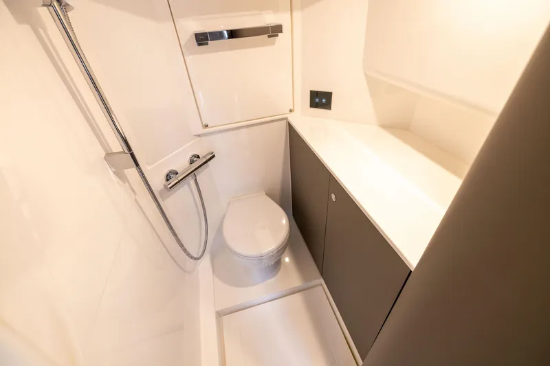 Slide: The Image of Modern bathroom interior on 2025 Fairline Squadron 58 yacht, featuring sleek fixtures and cabinetry. - 92