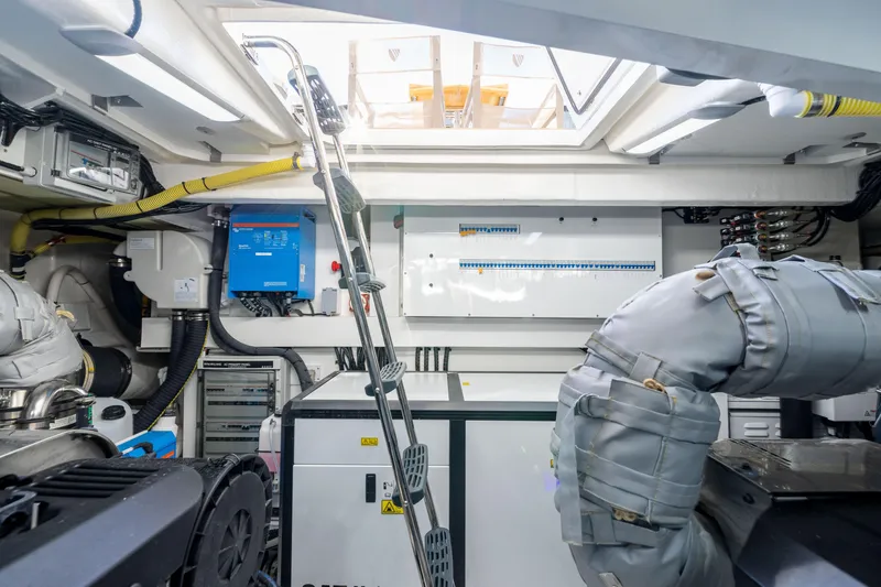 Slide: The Image of Engine room of 2025 Fairline Squadron 58 yacht, featuring modern equipment and ladder access. - 99