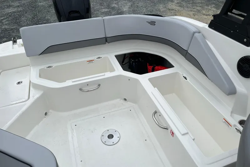 Slide: The Image of 2026 Bayliner V20 boat interior with storage compartments and cushioned seating. - 10