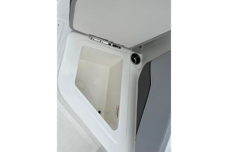 Slide: The Image of 2026 Bayliner V20 boat storage compartment with open lid, showcasing interior space. - 12