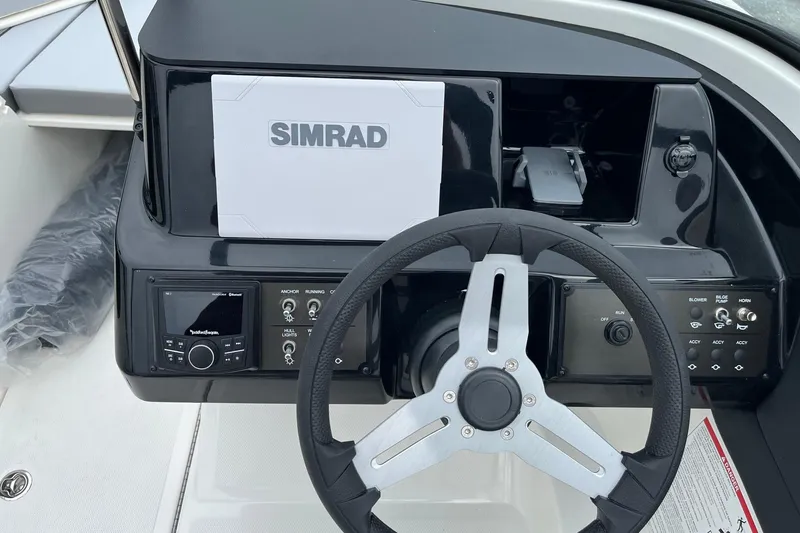 Slide: The Image of 2026 Bayliner V20 dashboard with Simrad display and steering wheel. - 14