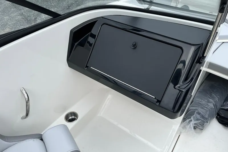 Slide: The Image of 2026 Bayliner V20 boat interior with sleek black storage compartment and modern design. - 15
