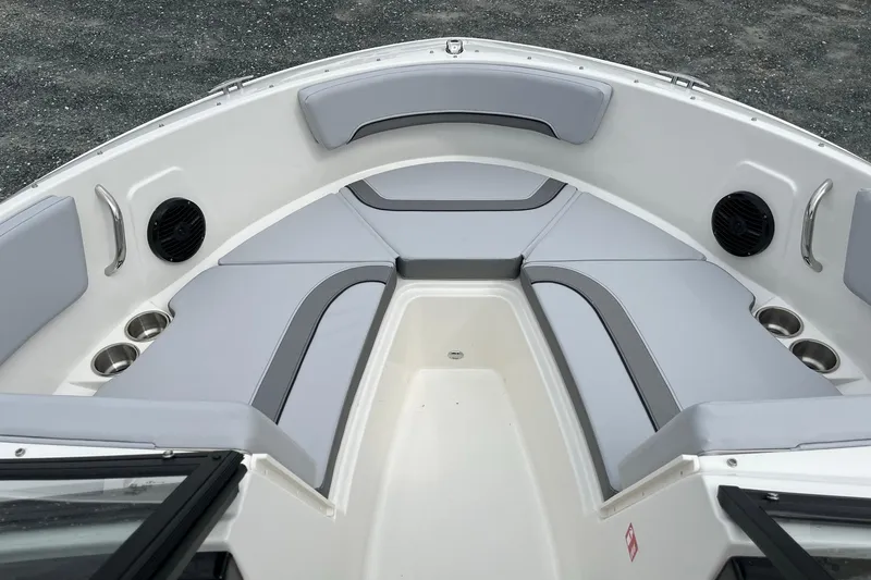 Slide: The Image of 2026 Bayliner V20 boat interior with gray seating and cup holders. - 19